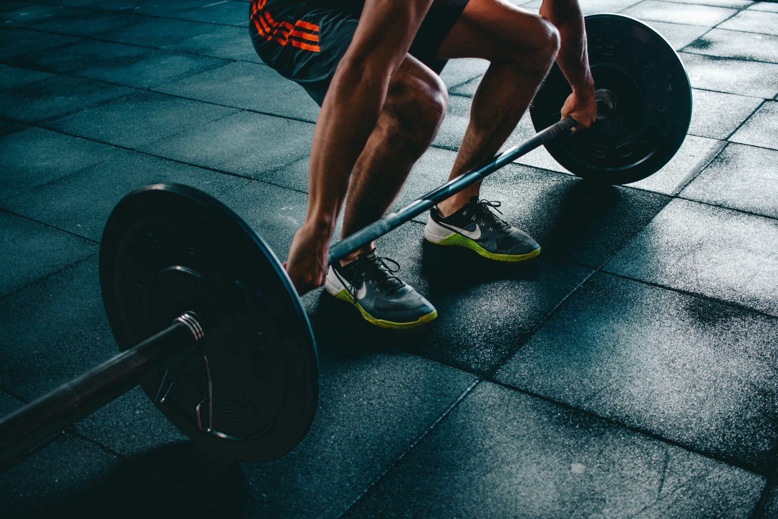 man bent down lifting weight