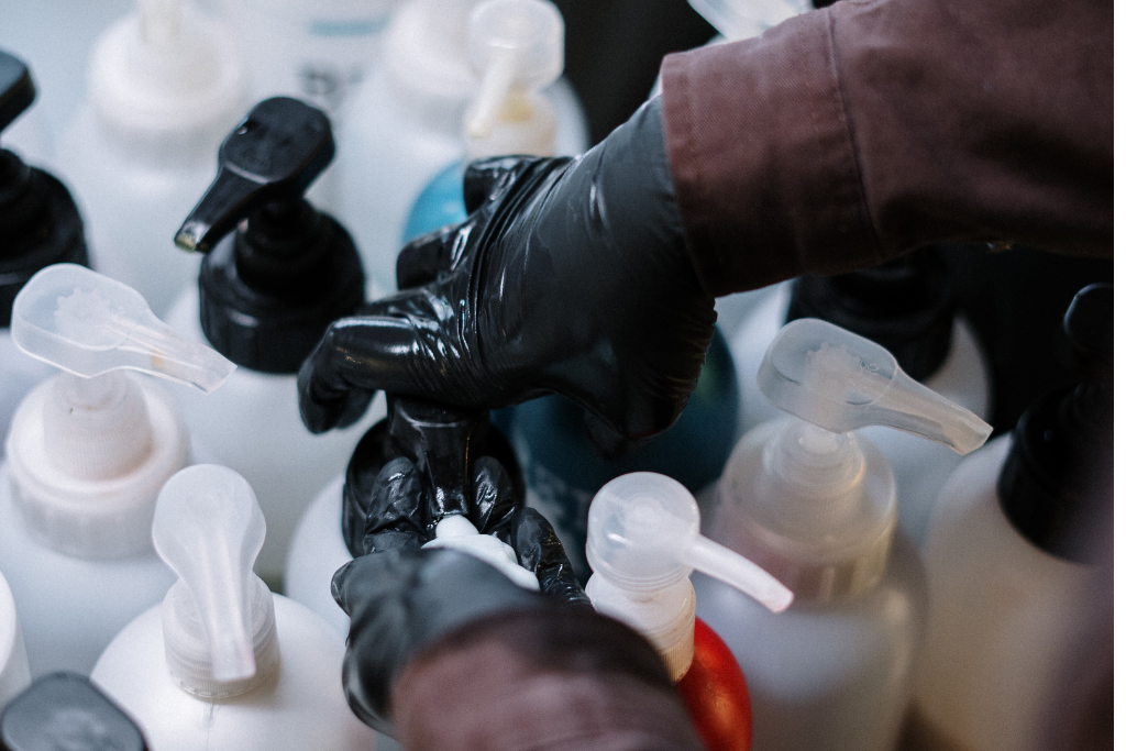 gloved hands working with chemical components